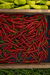 Green and red peppers, on the shelves, in a store In Thailand. Vegetables and food of Asia photos