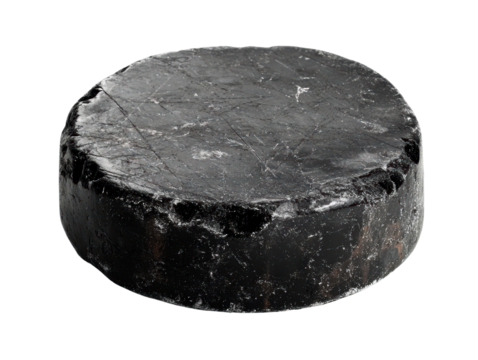 Black hockey puck on a white isolate background.