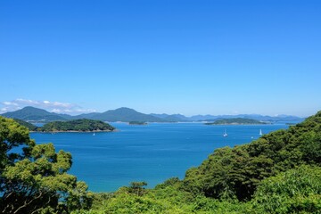Serene coastal view of lush green hills meeting tranquil blue waters on a sunny day
