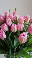 Fototapeta premium Delicate pink tulips in a lush bouquet, bringing spring's charm into a bright home setting