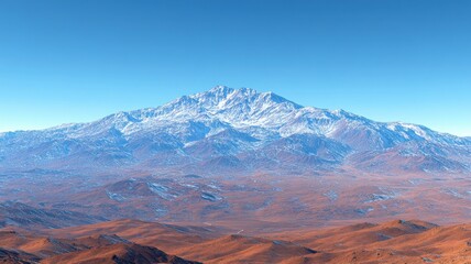 Obraz premium Snow-capped mountain range under clear blue sky.