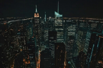 Aerial helicopter drone shot of new york city at night. Medium close of glass buildings, skyscrapers, lights reflecting.