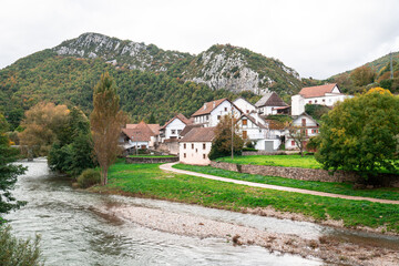 a river runs through a village in the mountains.  Aribe , Navarra