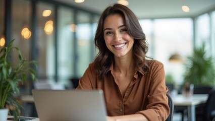 Young Professional Smiling While Working on Laptop in Stylish Office