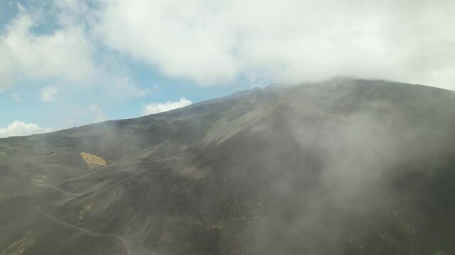 A drone soars high above the dormant crater of Etna. This is a unique journey through the clouds over one of the world&rsquo;s most famous volcanic landscapes, a natural landmark.