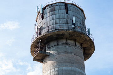 Old water tower with cell phone antennas.