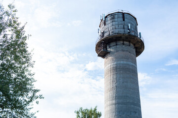 Old water tower with cell phone antennas.