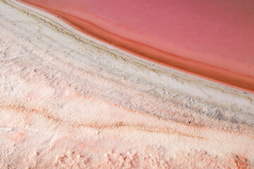 Colorful textures of the pink lagoon in the saltworks of Santa Pola town, Spain