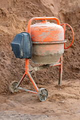 Old concrete mixer at a construction site.