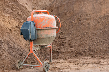 Old concrete mixer at a construction site.