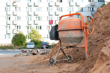Old concrete mixer at a construction site.