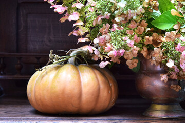 Autumn composition of flowers and pumpkin