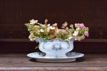 Autumn composition of flowers in vintage sauceboat