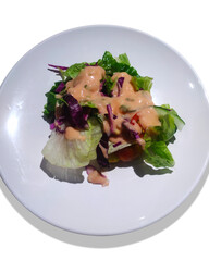Mini salad on white plate isolated on white background. Can be used for food menu photos.