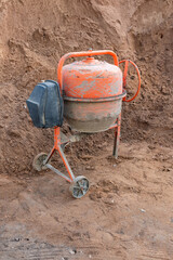 Old concrete mixer at a construction site.
