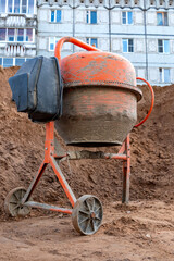 Old concrete mixer at a construction site.