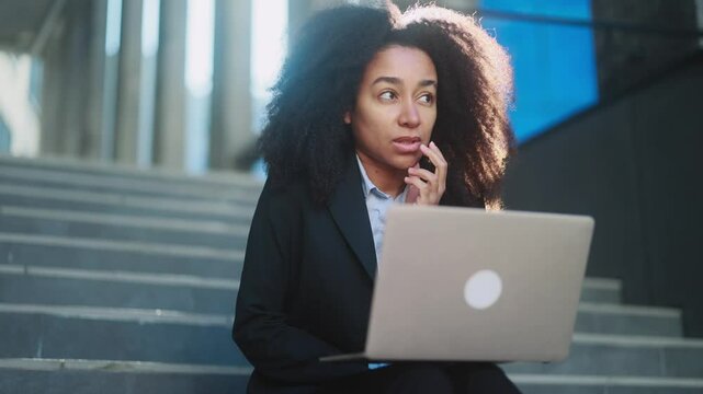 Portrait of beautiful young businesswoman thinks questioningly about difficult choice choose imagine plan in mind has doubts create idea with laptop computer at modern business centre	