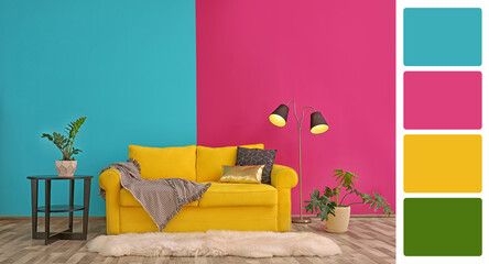 Stylish living room with comfortable sofa near colorful wall. Interior design and matching color...