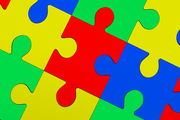 Obraz premium Many colorful puzzle pieces as background. Symbol of autism