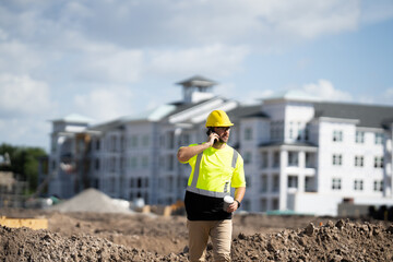 Civil Worker engineer african american man wearing hard hat and smiling. happy positive manager or contractor, heavy machinery. Construction worker on top of a building. builder in working uniform