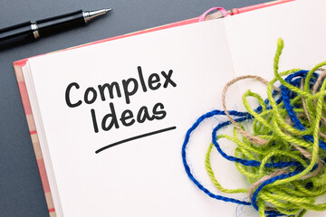 Complex Ideas text, and topic on the notebook with part of tangled jute rope, simplify writing...