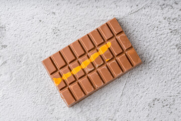 Dubai Chocolate bar with green kadayif and peanut butter on white stone table