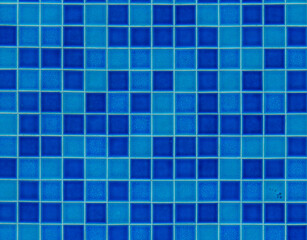 Vibrant blue mosaic tiles create a calming atmosphere in a tranquil swimming pool area during midday sunlight