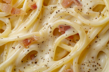 Close-up shot of spaghetti carbonara coated in rich creamy sauce with parmesan. Italian food concept