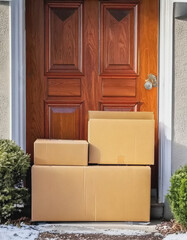  Brown delivery boxes at a front home door with light dusting of snow AI
