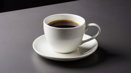 Fototapeta premium A sleek white cup holds freshly brewed coffee on a matching saucer against a smooth gray background. The scene captures a tranquil coffee moment.