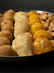Indian sweets in a plate includes anarsa, shakkarpara morichoor  Bundi Laddu, Gujiya or Karanji for diwali celebration