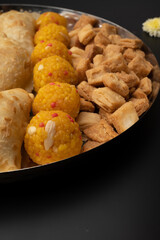 Indian sweets in a plate includes anarsa, shakkarpara morichoor  Bundi Laddu, Gujiya or Karanji for diwali celebration