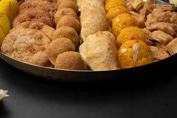 Indian sweets in a plate includes anarsa, shakkarpara morichoor  Bundi Laddu, Gujiya or Karanji for diwali celebration