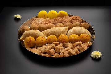 Indian sweets in a plate includes anarsa, shakkarpara morichoor  Bundi Laddu, Gujiya or Karanji for diwali celebration