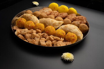Indian sweets in a plate includes anarsa, shakkarpara morichoor  Bundi Laddu, Gujiya or Karanji for diwali celebration