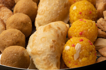 Indian sweets in a plate includes anarsa, shakkarpara morichoor  Bundi Laddu, Gujiya or Karanji for diwali celebration