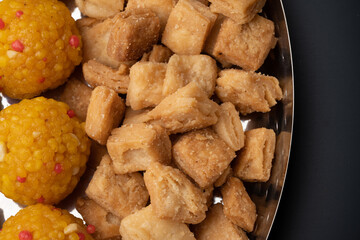 Indian sweets in a plate includes anarsa, shakkarpara morichoor  Bundi Laddu, Gujiya or Karanji for diwali celebration