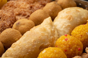 Indian sweets in a plate includes anarsa, shakkarpara morichoor  Bundi Laddu, Gujiya or Karanji for diwali celebration
