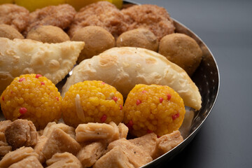 Indian sweets in a plate includes anarsa, shakkarpara morichoor  Bundi Laddu, Gujiya or Karanji for diwali celebration