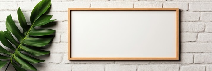 Blank Canvas Mockup with a Tropical Leaf on a White Brick Wall, Perfect for Art, Design, or Photography Presentation