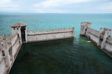 Fortress walls of the castle in Sirmione (Castello Scaligero di Sirmione), one of the most spectacular and preserved fort on Lake Garda, province of Brescia, Italy.