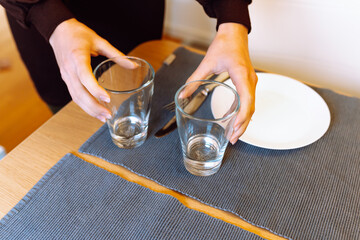 female hands clearing glass glasses from table © larisikstefania