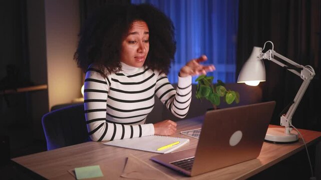 Shocked pretty african american woman reacting to news and feel confused surprised ashamed making face palm gesture disappointed in result having problem or bad news at home workplace late at hight