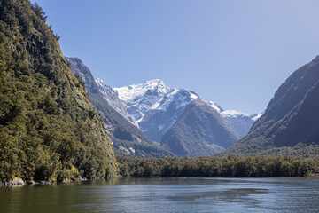 Milford sound fiord reflecting on water with snow capped mountains
