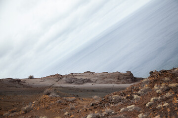 Volcanic rocks meeting the sea on a cloudy day on the island of lanzarote
