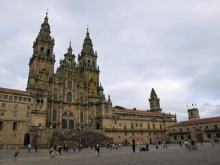 Fototapeta premium Tourists walking in obradoiro square with the cathedral in the background, santiago de compostela, spain