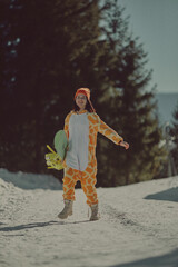  A girl with a snowboard in her hands against the backdrop of snowy mountains