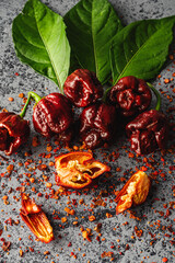 Variety of Spicy Peppers Including Aji Limo, Habanero, and Carolina Reaper on a Vibrant Background