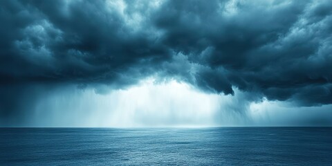 Fototapeta premium Dramatic storm clouds over a tranquil sea, creating a contrasting landscape.