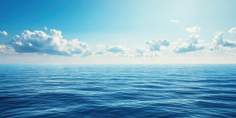 Obraz premium Expansive ocean view with peaceful waves and bright blue sky.